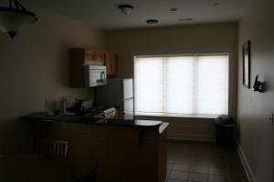 a kitchen with a window with a microwave and a refrigerator at Hotel Floyd in Floyd