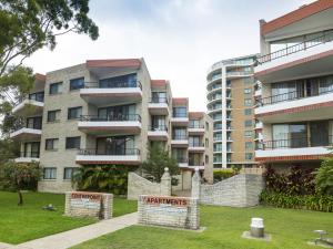 an apartment building with a sign in front of it at Centrepoint 10 in Forster