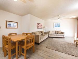 a living room with a table and a couch at Centrepoint 10 in Forster