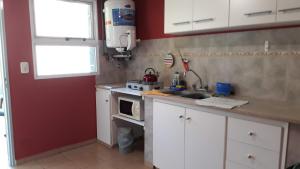 a small kitchen with a sink and a microwave at Departamento céntrico en San Pedro in San Pedro