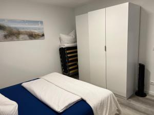 a bedroom with a bed and a closet at Apartment Montabaur Heiligenroth in Heiligenroth