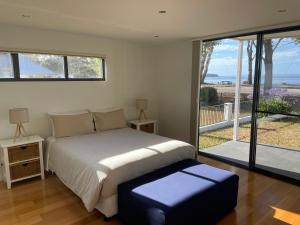 a bedroom with a bed and a large window at Gull Apartment in Strahan