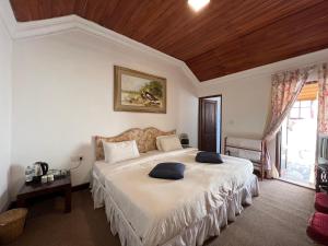 Postel nebo postele na pokoji v ubytování Tea Bush Hotel