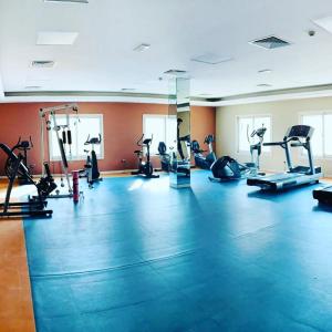 a gym with treadmills and elliptical machines at LADIES ONLY-AnaRuby Backpackers - Metro Station Mashreq in Dubai
