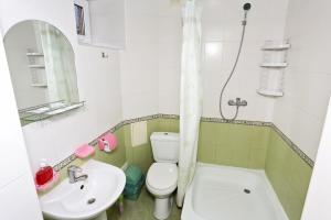 a bathroom with a toilet and a sink and a tub at Villa Blues Guest House in Koktebel