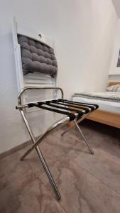 una silla blanca sentada junto a una cama en Gemütliche Ferienwohnung Reinsfeld en Reinsfeld