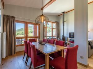 a dining room with a table and red chairs at Appartement Les Arcs 1800, 5 pièces, 8 personnes - FR-1-352-59 in Arc 1800