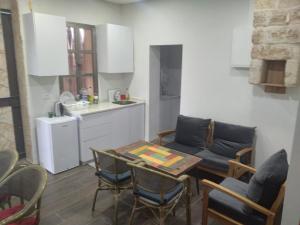 a kitchen and a living room with a table and chairs at BenGurion 25 Apartment in Haifa +8 photos