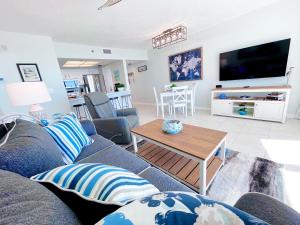 a living room with a couch and a table at Emerald Bay Escape in Panama City Beach