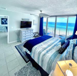a bedroom with a bed and a view of the ocean at Emerald Bay Escape in Panama City Beach
