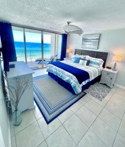 a bedroom with a bed with a view of the ocean at Emerald Bay Escape in Panama City Beach