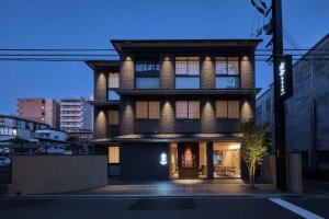 a large brick building with lights on at Stay SAKURA Kyoto SUZAKU OJI in Kyoto