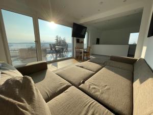 a large bed in a room with a large window at Penthouse mit Ausblick in Bad Schwalbach