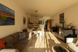 a living room with a couch and a table at Apartment Casino in Nieuwpoort