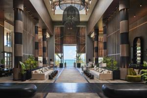 a lobby with couches and a view of the ocean at LUX* Grand Baie Resort & Residences in Grand Baie