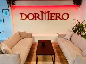 a living room with two couches and a coffee table at DORMERO Hotel Bretten in Bretten