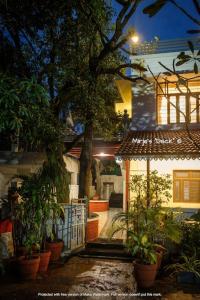 a house with potted plants in front of it at Mirje's Deck - Homestay - Family Rooms in Kolhapur