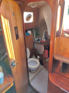 a bathroom with a toilet in the back of a van at Sleep on a Sailing Boat Barcelona in Barcelona