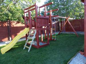 a playground with a ladder and a slide at Oregano Apartman By BLTN in Siófok