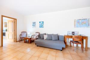 a living room with a couch and a table and chairs at Praia da Luz Monique Apartment in Luz