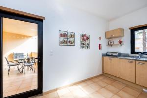 a kitchen with a door leading to a dining room at Praia da Luz Monique Apartment in Luz