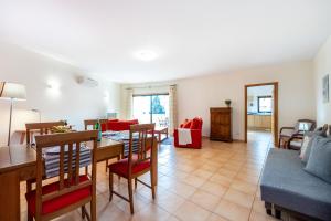 a living room with a table and a dining room at Praia da Luz Monique Apartment in Luz