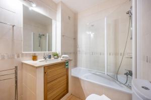 a bathroom with a tub and a sink and a shower at Praia da Luz Monique Apartment in Luz