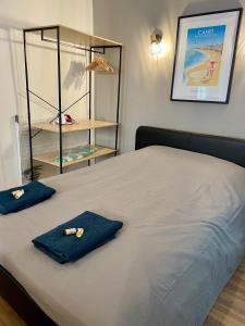 Un dormitorio con una cama con toallas azules. en République - Dauder de Selva, en Perpiñán