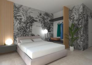Un dormitorio con una cama blanca y una pared con plantas. en Marty Luxury B&B, en Calatabiano