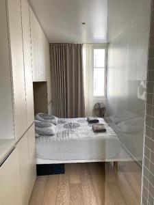 a bedroom with a bed and a glass wall at My Trip in Paris - Eiffel Tower in Paris