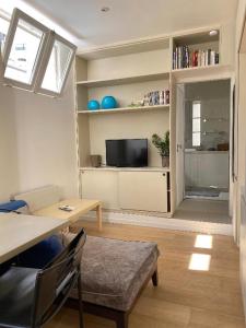 a living room with a table and a tv at My Trip in Paris - Eiffel Tower in Paris