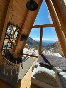 a room with a hammock in a tree house at Horizon Lodge Medurec in Ulcinj +6 photos