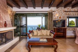 a living room with a couch and a fireplace at Xigia Escape villas in Khartáta