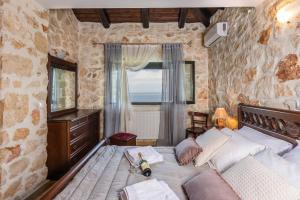 a bedroom with a large bed with a window at Xigia Escape villas in Khartáta