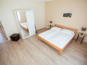 a bedroom with a bed and a mirror at Villa Sonnenschein in Laa an der Thaya