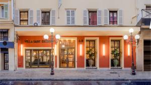 a building with two street lights in front of it at Villa Saint Exupery Beach Hostel in Nice