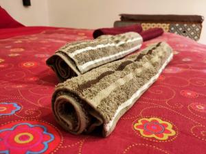 two towels are sitting on top of a bed at Interno 7 in Barletta