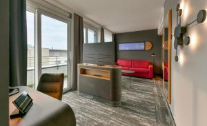 a hotel room with a red couch and a window at Best Western Plus Hotel Papenburg in Papenburg +172 photos