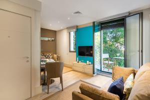 a living room with a couch and a dining room at Kronos on the Beach suite 1 in Barcelona