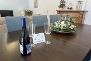 a bottle of wine sitting on a table with glasses at Luxury y Elegant Apartment in the centre in Barcelona