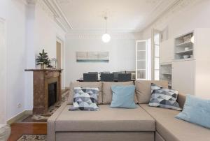 a living room with a couch and a fireplace at Luxury y Elegant Apartment in the centre in Barcelona