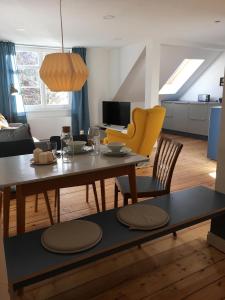 a living room with a table and yellow chairs at Rosinas - Fräulein Thäsler in Oberstaufen