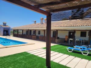 a villa with a swimming pool and a house at Casas Rurales Noguericas in Archivel