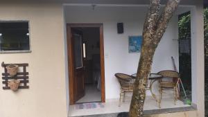 Casa de hospedes em condominio com lazer في بوزيوس: منزل به طاولة وكراسي بجوار باب