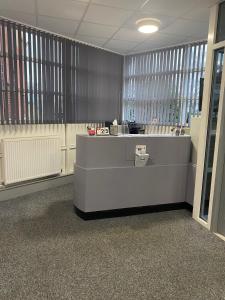 an office cubicle with a reception desk in a building at Premier Lodge in Falkirk