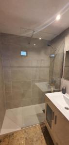 a bathroom with a glass shower and a sink at MARISCAL 3 - Fincas Arena in Benidorm
