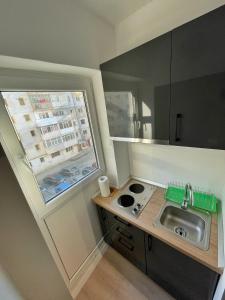 a small kitchen with a sink and a window at RCC 4 STUDIO in Focşani