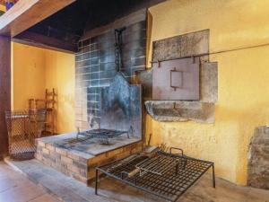 a brick fireplace with a stove in a room at Villa costa brava in Vehinat de las Ferreríes