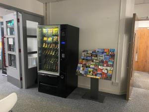 a refrigerator filled with lots of drinks in a room at Premier Lodge in Falkirk