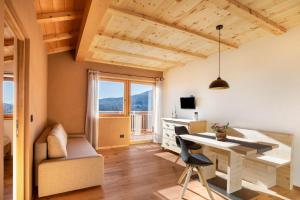 a small apartment with a desk and a chair at Brugghof Apartement Lärche in San Felice